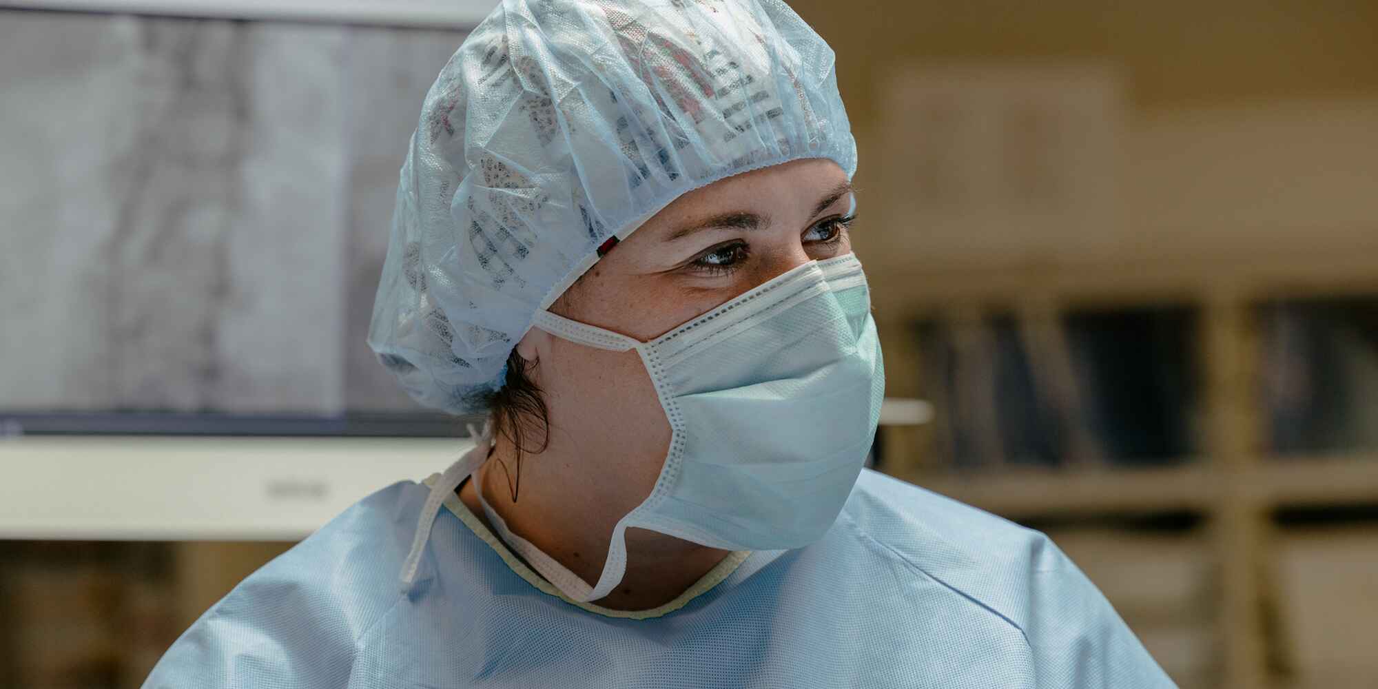 surgical nurse with haircover and mask